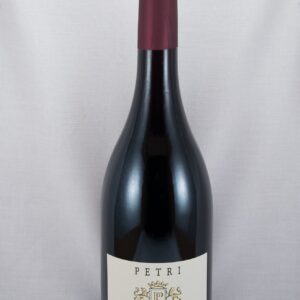 a bottle of red wine with a white label