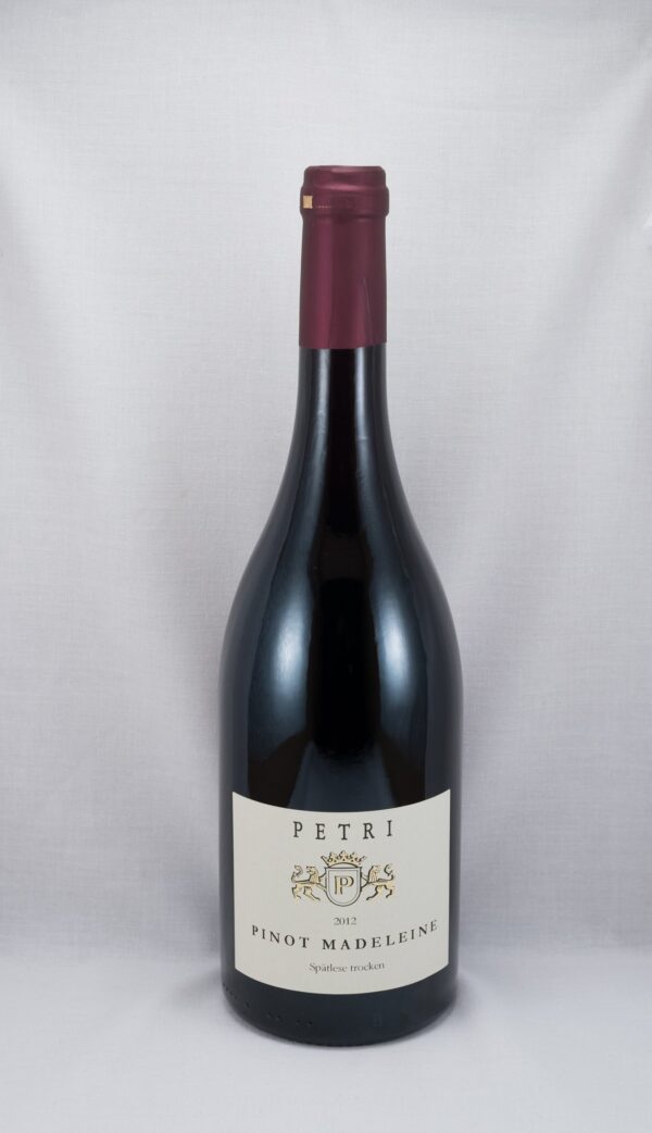 a bottle of red wine with a white label